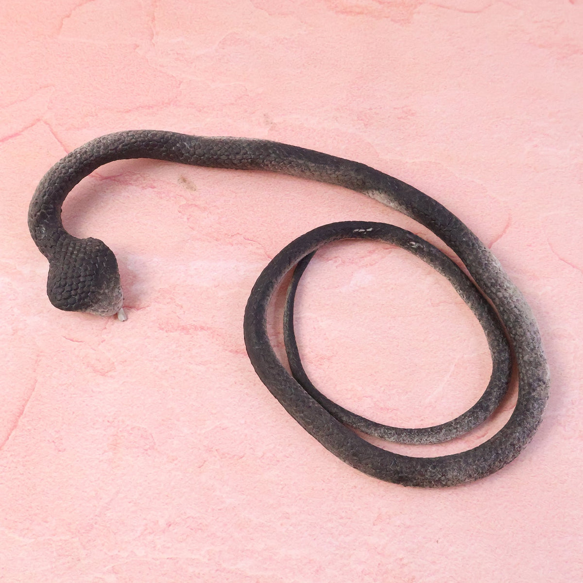 Lifelike fake snake toy designed for kidsโ pranks and garden protection
