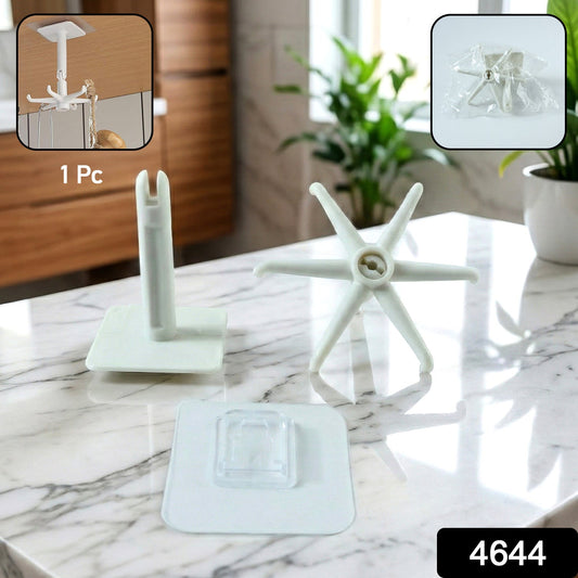 Multiple waterproof rotating wall hooks organizing kitchen utensils on a white tiled wall.